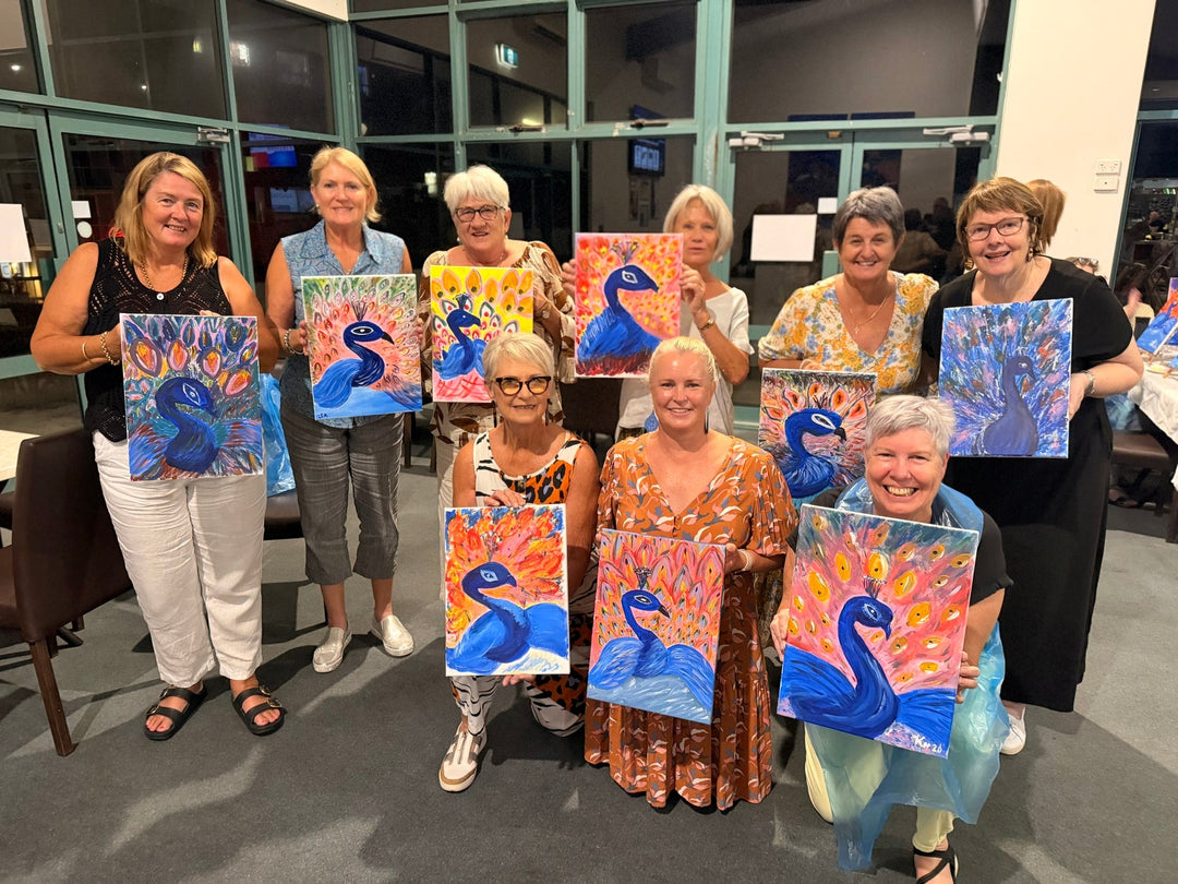 Bargara Paint and Sip attendees smiling with their artworks at Paint Juicy
