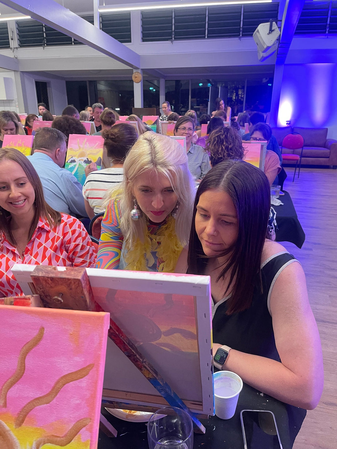 Artist talking to customer about painting