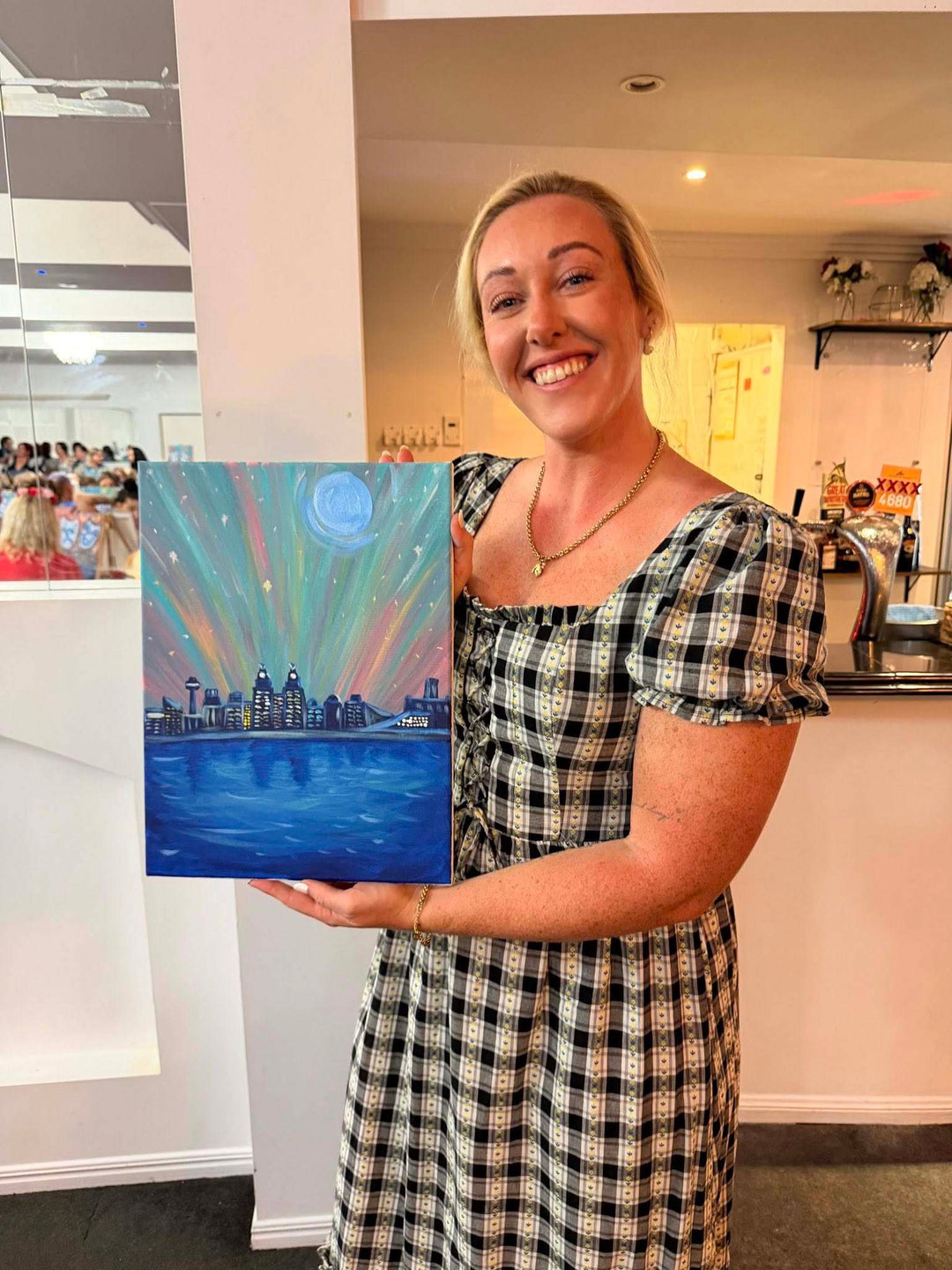 Gladstone Paint and Sip customer smiling with artwork theyve created