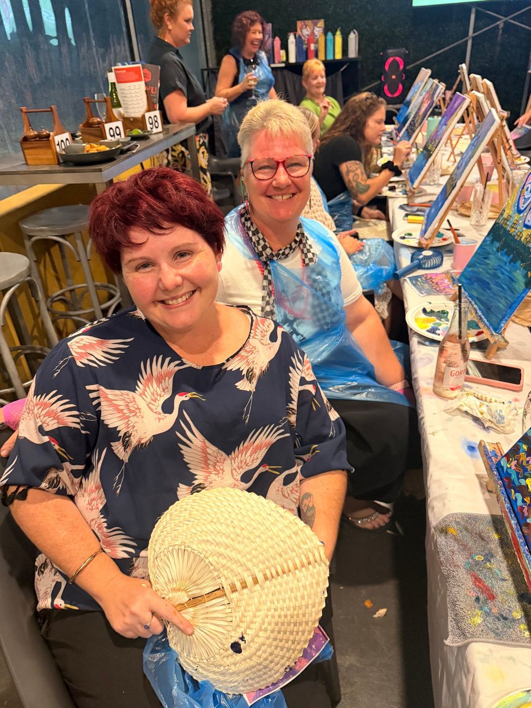 Mackay paint and sip customers smiling with their artworks at Paint Juicy