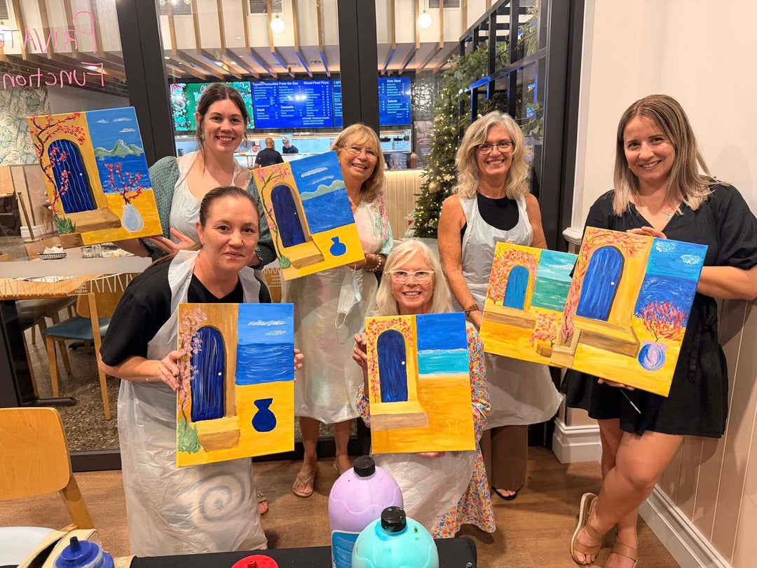Twonsville Paint and Sip customers smiling with their artworks at Paint Juicy