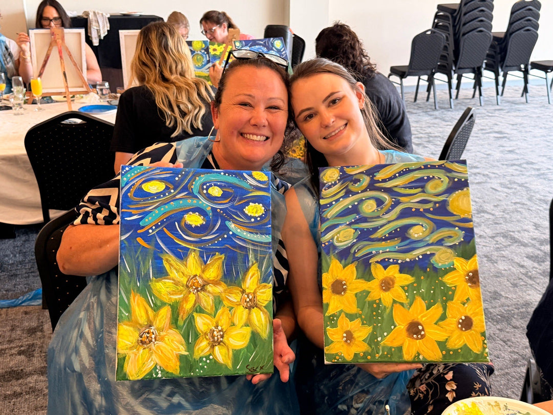 Ladies smiling with their paint and sip artworks in Wyong