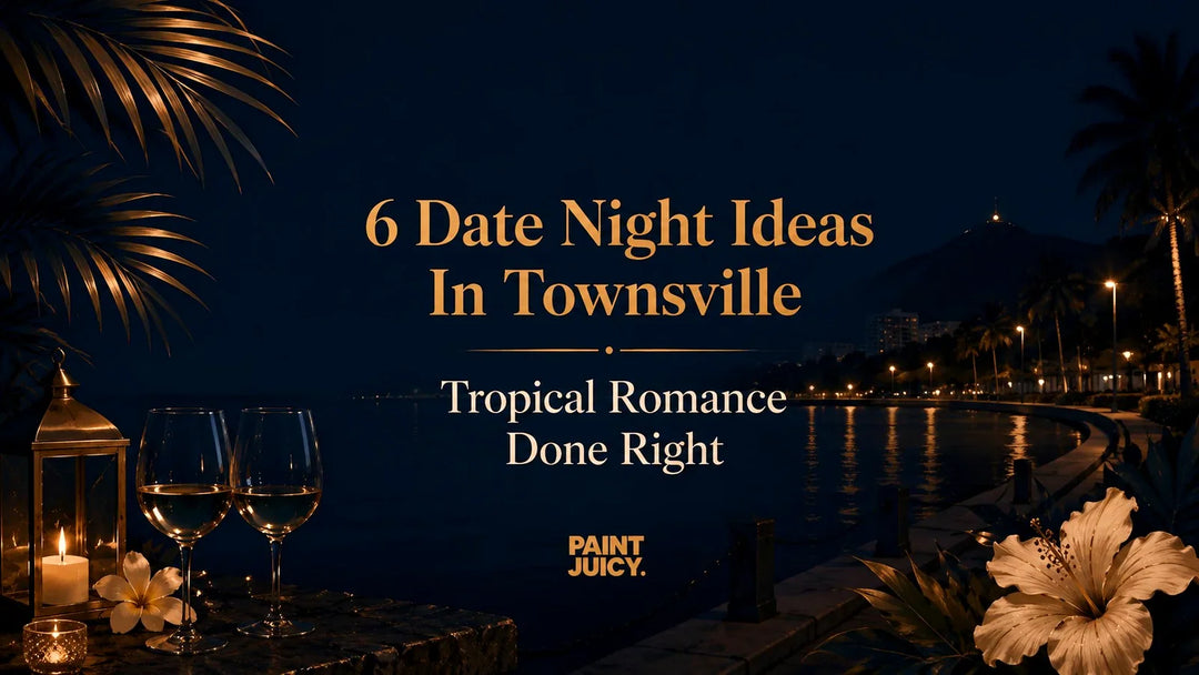 Paint Juicy date night ideas in Townsville, The Strand waterfront at night with Castle Hill and two wine glasses