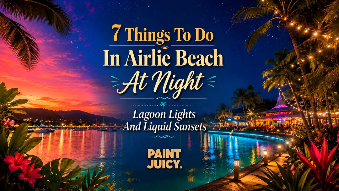 Paint Juicy things to do in Airlie Beach at night, the lagoon boardwalk and marina glowing with string lights under a sunset sky