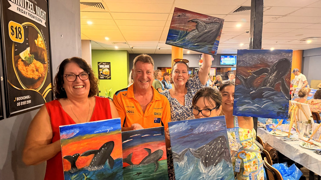 Group of five Parap Tavern Paint and Sip guests holding their finished humpback whale paintings on a Sunday session