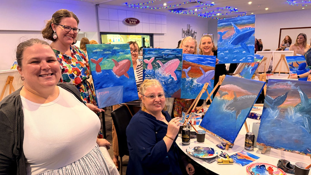 Wide shot of Rockhampton Paint and Sip in full swing with multiple guests painting their humpback whale canvases