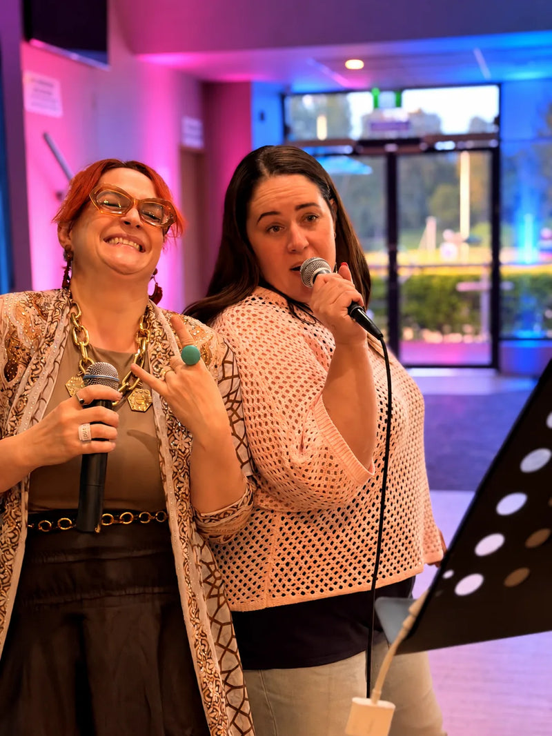 Two guests on the microphones for a karaoke duet at a Central Coast paint and sip, The Davo RSL in Davistown