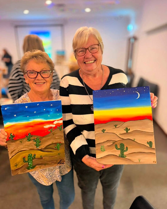 Paint Juicy guests holding their finished Prick My Interest cactus paintings at a paint and sip night, photo 3 of 6