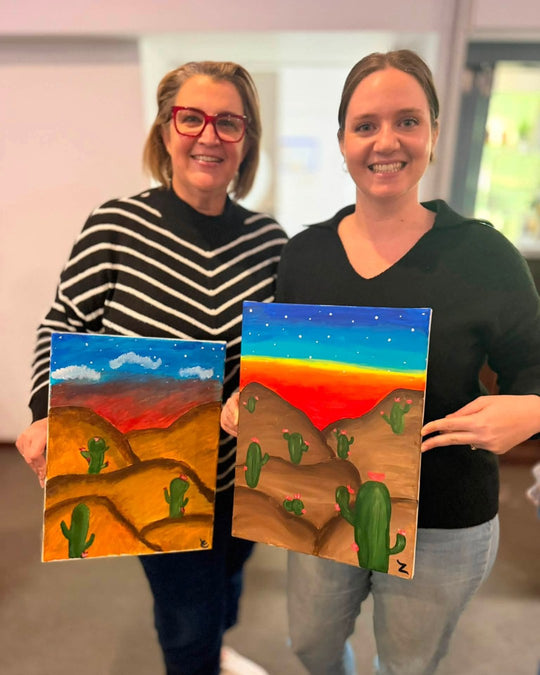 Paint Juicy guests holding their finished Prick My Interest cactus paintings at a paint and sip night, photo 4 of 6