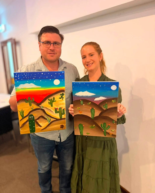 Paint Juicy guests holding their finished Prick My Interest cactus paintings at a paint and sip night, photo 5 of 6