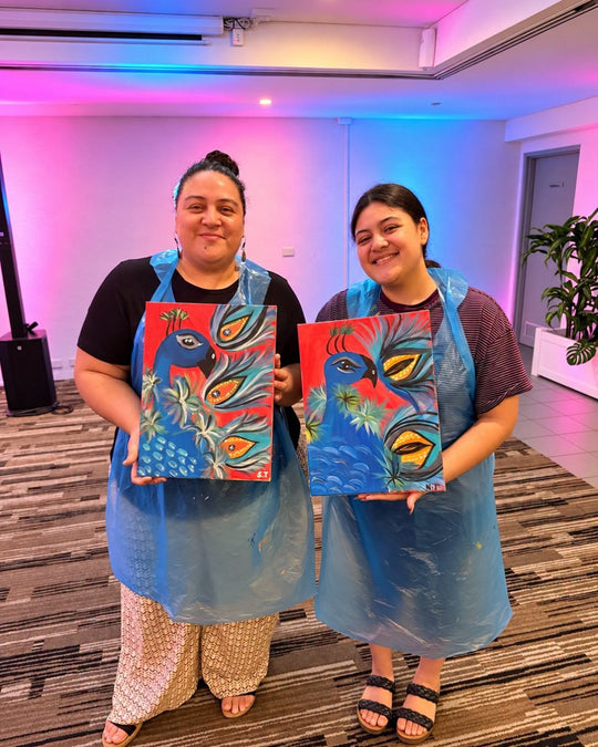Paint Juicy guests holding their finished The Red Peacock paintings at a paint and sip night, photo 4 of 4