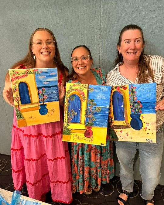 Paint Juicy guests holding their finished Santorini Door paintings at a paint and sip night, photo 6 of 6