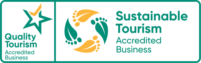 Two logos for Quality Tourism and Sustainable Tourism Accredited Business on a white background.