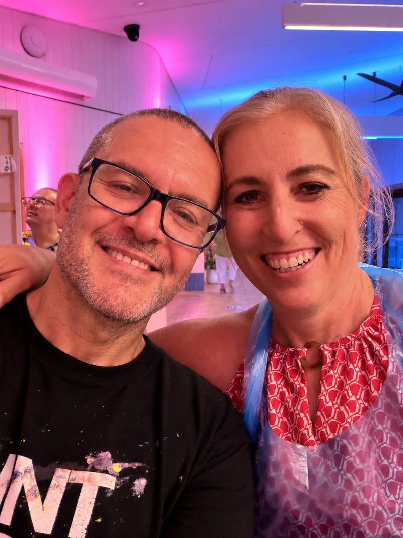 Paint Juicy host and a smiling guest in her apron sharing a selfie at a Sunshine Coast paint and sip night
